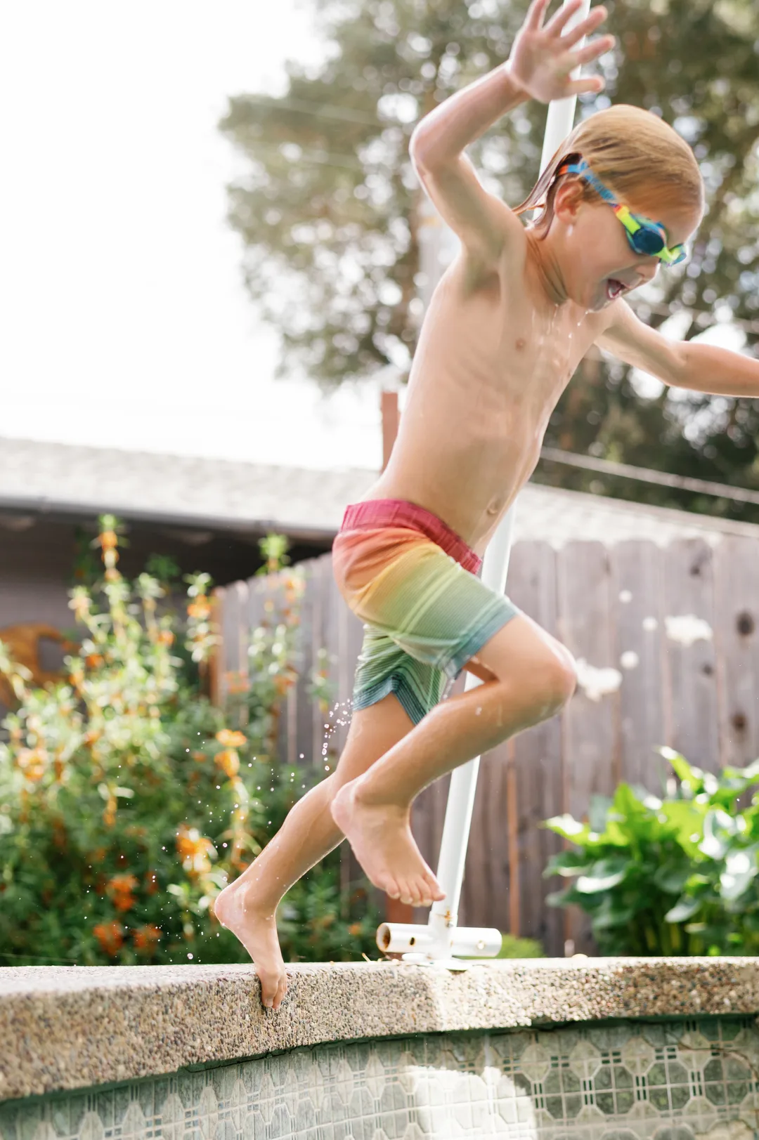 Young swimmer jumping into the pool at Little Fish Swim School