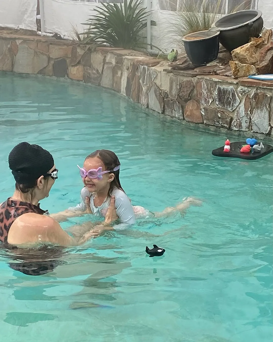 Parent watching as their child builds swimming confidence at Little Fish