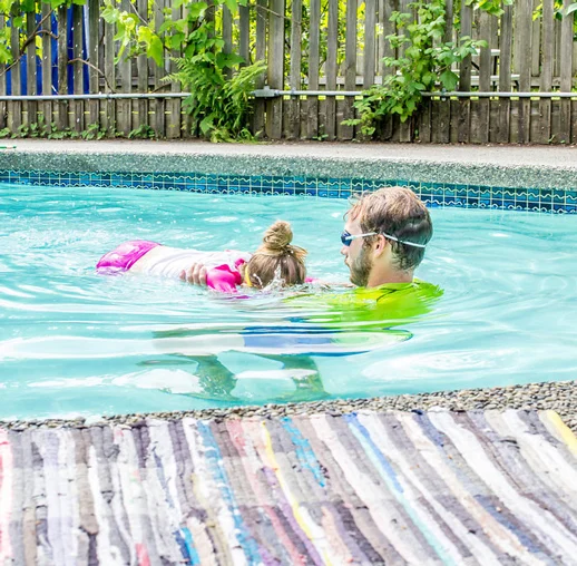 Instructor working with young swimmer