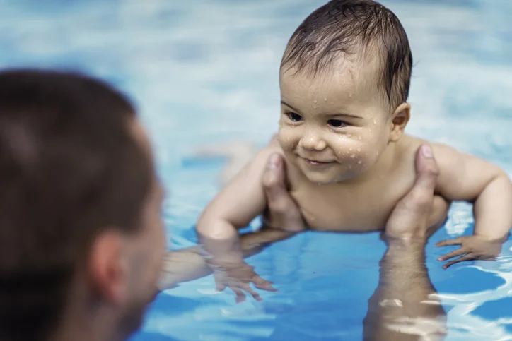 Infant smiling during a Sing-Along Swim class