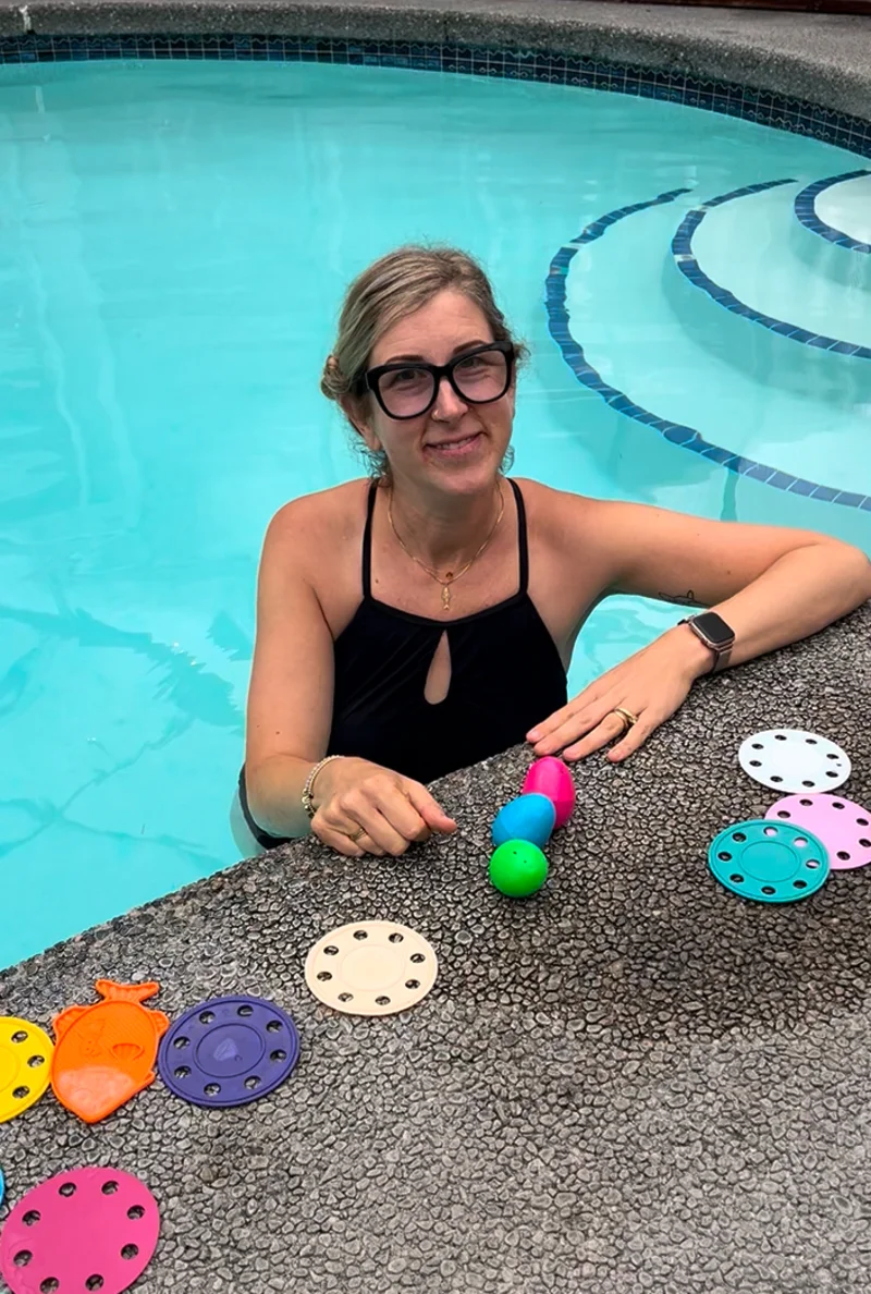 Swim instructor with child in pool